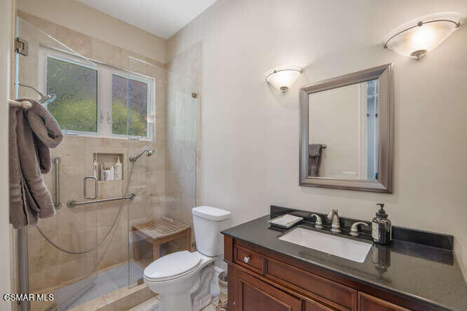421 Whitegate Road Newbury Park, CA 91320 - Photo 31 of 76 a bathroom with a granite countertop sink mirror vanity and toilet