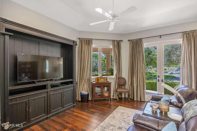 421 Whitegate Road Newbury Park, CA 91320 - Photo 34 of 76 a living room with furniture a flat screen tv and floor to ceiling window
