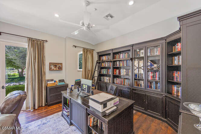 421 Whitegate Road Newbury Park, CA 91320 - Photo 35 of 76 a living room with furniture a bookshelf and a window