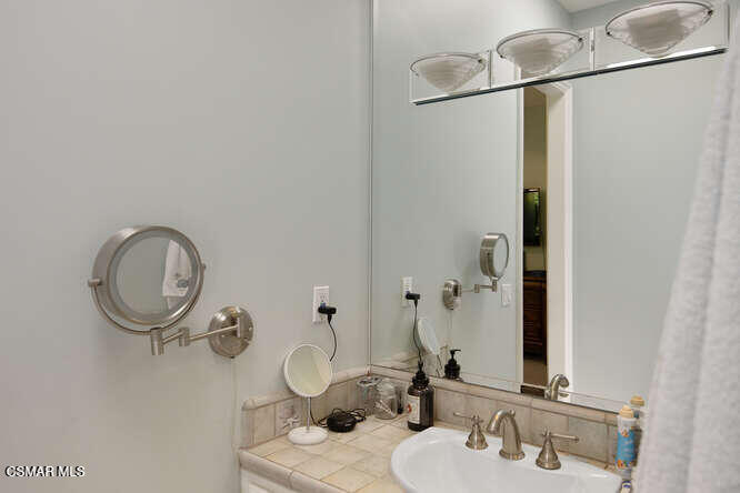 421 Whitegate Road Newbury Park, CA 91320 - Photo 38 of 76 a bathroom with a sink and a mirror