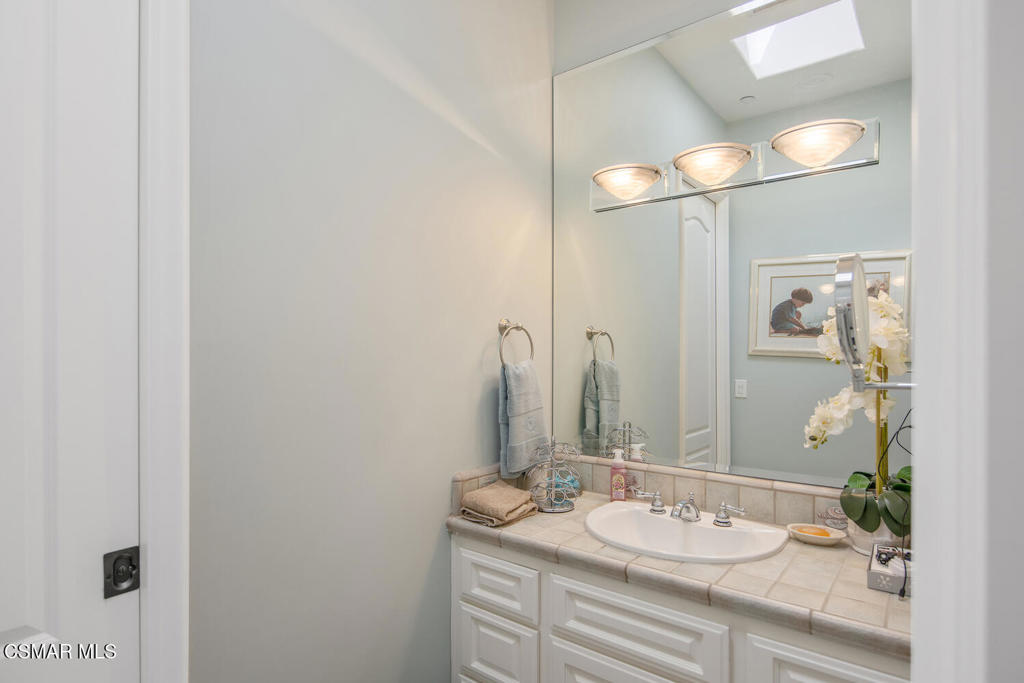 421 Whitegate Road Newbury Park, CA 91320 - Photo 44 of 76 a bathroom with a granite countertop sink and a mirror