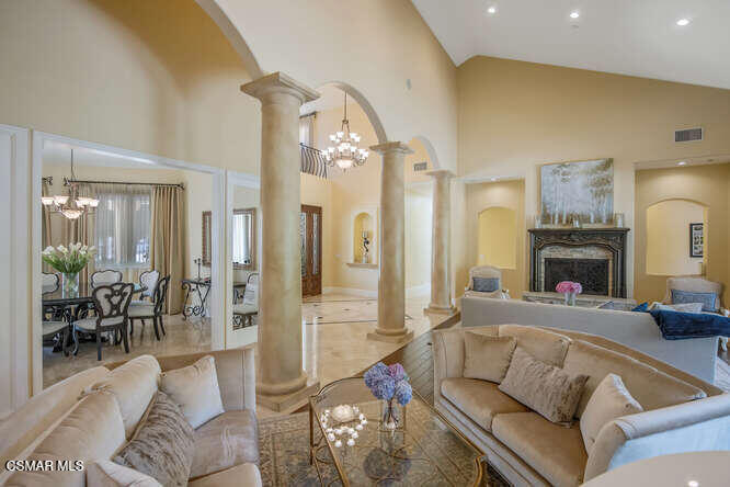 421 Whitegate Road Newbury Park, CA 91320 - Photo 5 of 76 a living room with furniture a fireplace and a chandelier