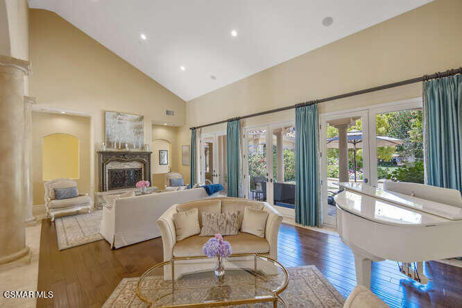 421 Whitegate Road Newbury Park, CA 91320 - Photo 6 of 76 a living room with furniture large windows and wooden floor