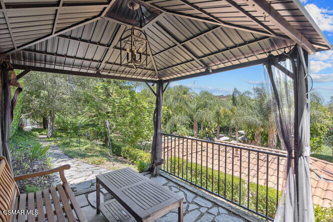 421 Whitegate Road Newbury Park, CA 91320 - Photo 62 of 76 a view of a patio with table and chairs and wooden floor
