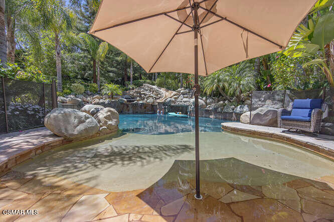421 Whitegate Road Newbury Park, CA 91320 - Photo 65 of 76 a view of a backyard patio with table and chairs under an umbrella