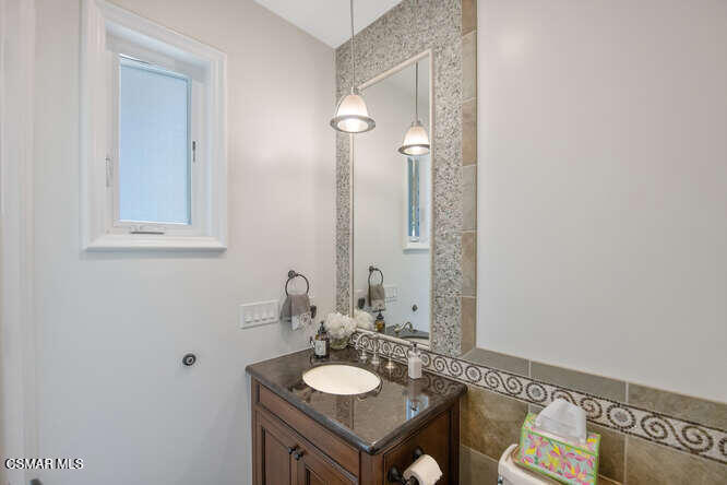 421 Whitegate Road Newbury Park, CA 91320 - Photo 70 of 76 a bathroom with a granite countertop sink and a mirror