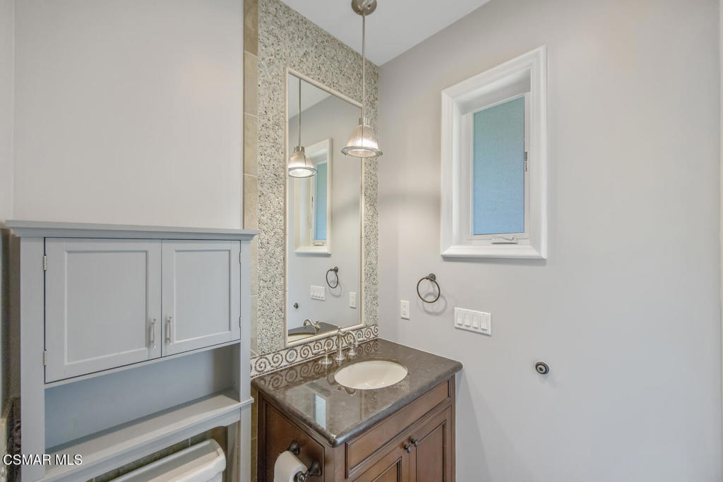 421 Whitegate Road Newbury Park, CA 91320 - Photo 76 of 76 a bathroom with a granite countertop sink and a mirror