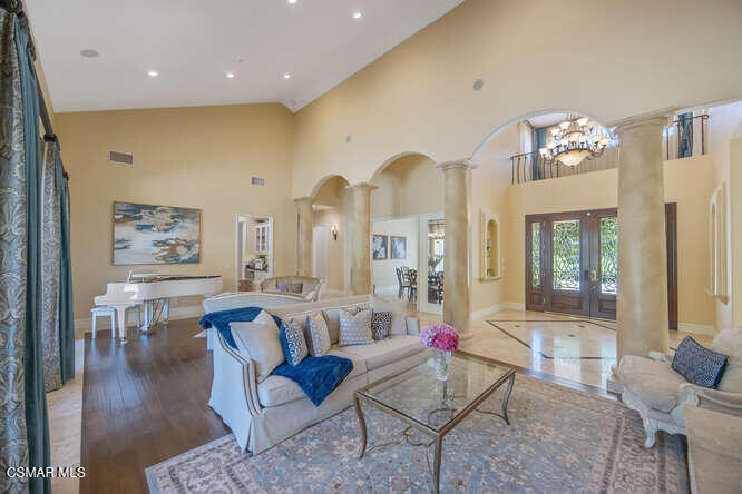 421 Whitegate Road Newbury Park, CA 91320 - Photo 8 of 76 a living room with couches chairs and kitchen view with wooden floor