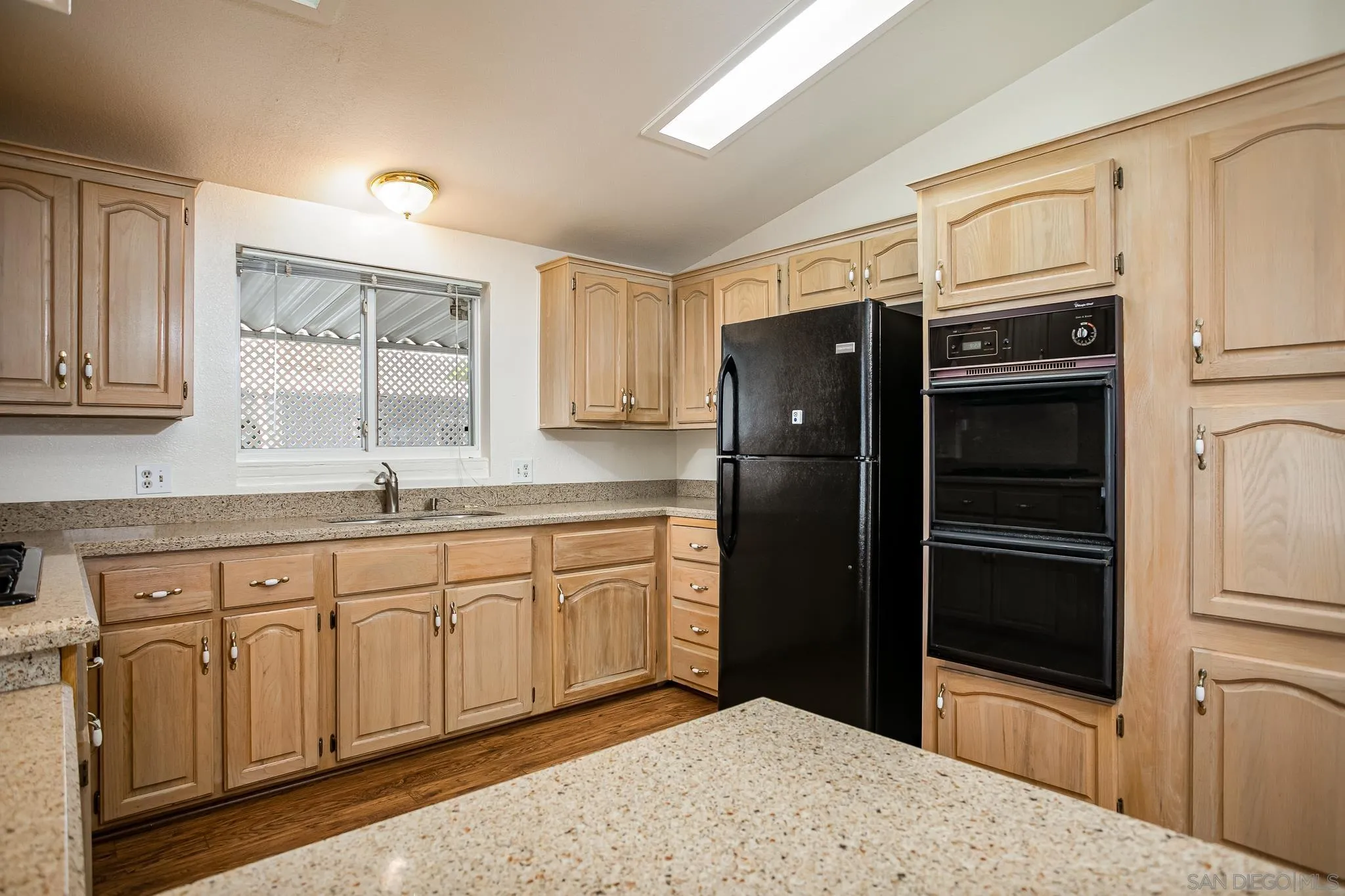 11949 Riverside Drive, Unit SPC 186 Lakeside, CA 92040 - Photo 12 of 40 a kitchen with granite countertop a refrigerator and cabinets