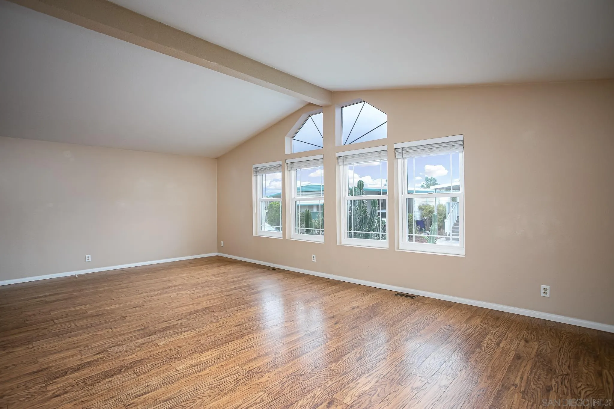 11949 Riverside Drive, Unit SPC 186 Lakeside, CA 92040 - Photo 8 of 40 a view of an empty room with wooden floor and a window
