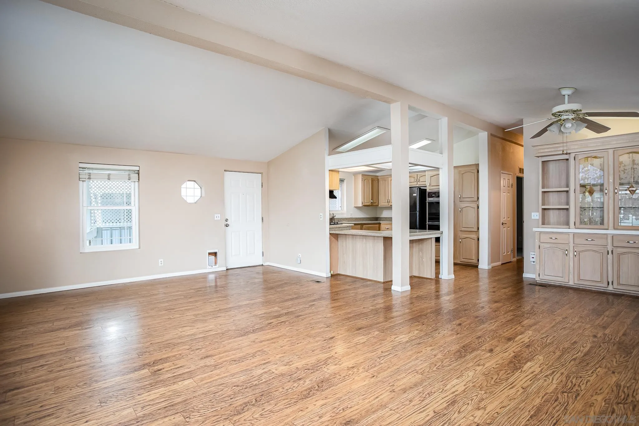 11949 Riverside Drive, Unit SPC 186 Lakeside, CA 92040 - Photo 9 of 40 a view of empty room with wooden floor and kitchen view