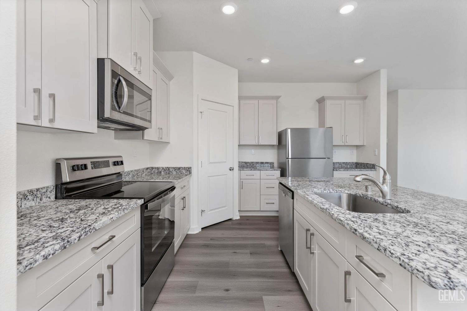 Undisclosed Address Bakersfield, CA 93313 - Photo 3 of 10 a kitchen with stainless steel appliances granite countertop a sink stove and refrigerator