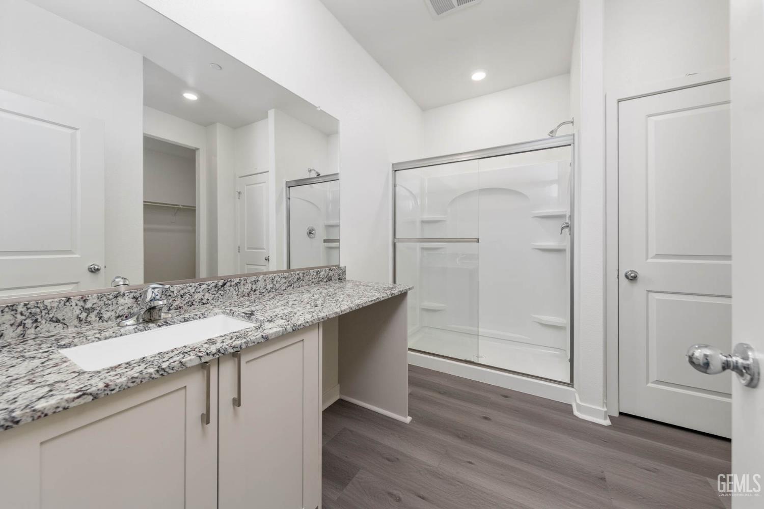 Undisclosed Address Bakersfield, CA 93313 - Photo 4 of 10 a bathroom with a granite countertop sink and a mirror