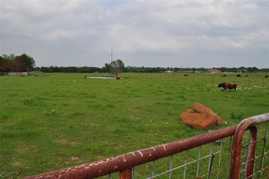 620 South Kaufman Street Seagoville, TX 75159 - Photo 3 of 5 a view of a green field of grass and trees