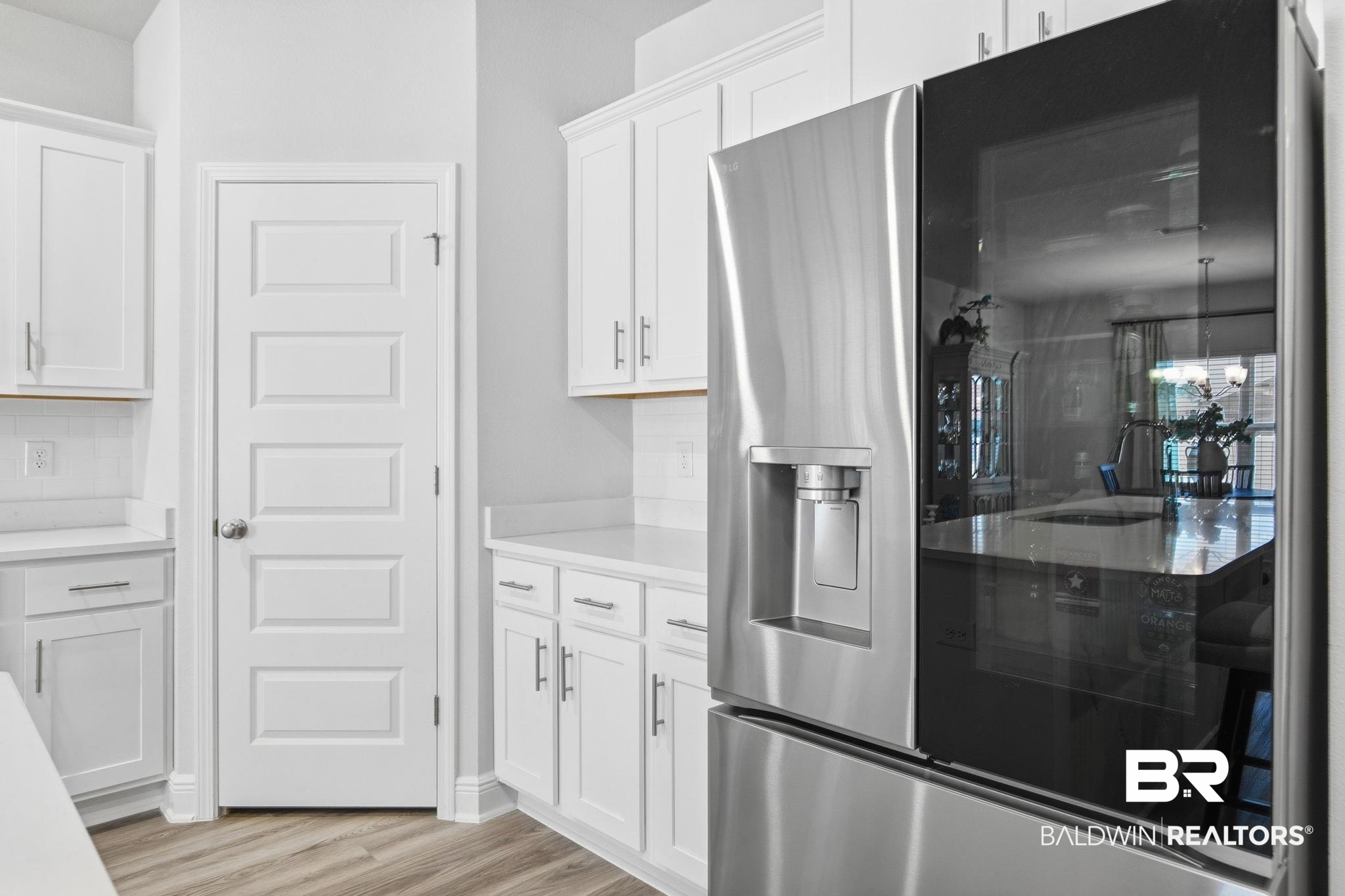 11123 Genuine Risk Circle Daphne, AL 36526 - Photo 20 of 67 Kitchen featuring stainless steel fridge, white cabinets, light wood finished floors, and light stone counters
