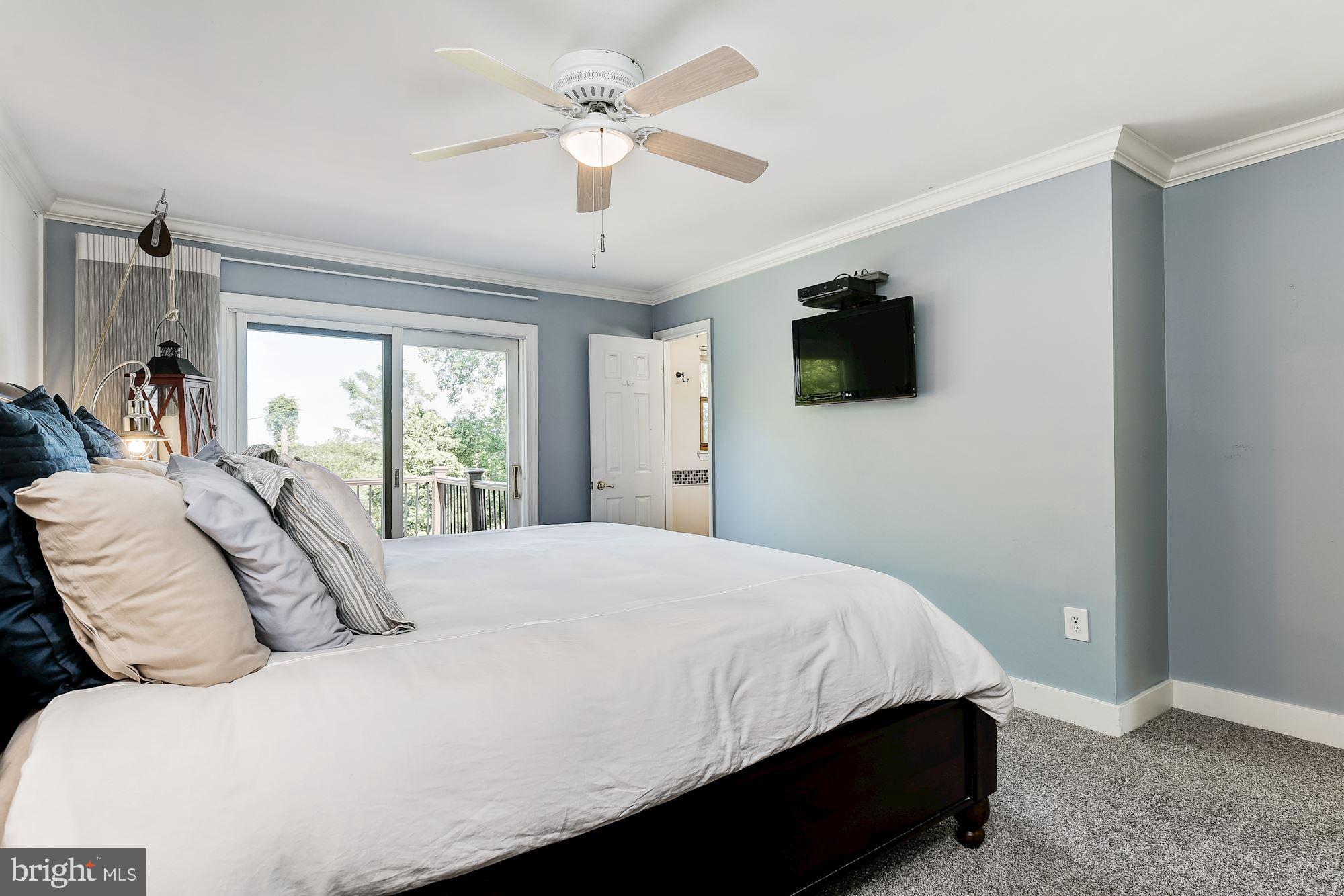 3069 Riverview Road Riva, MD 21140 - Photo 19 of 38 a bedroom with a large bed and a flat screen tv
