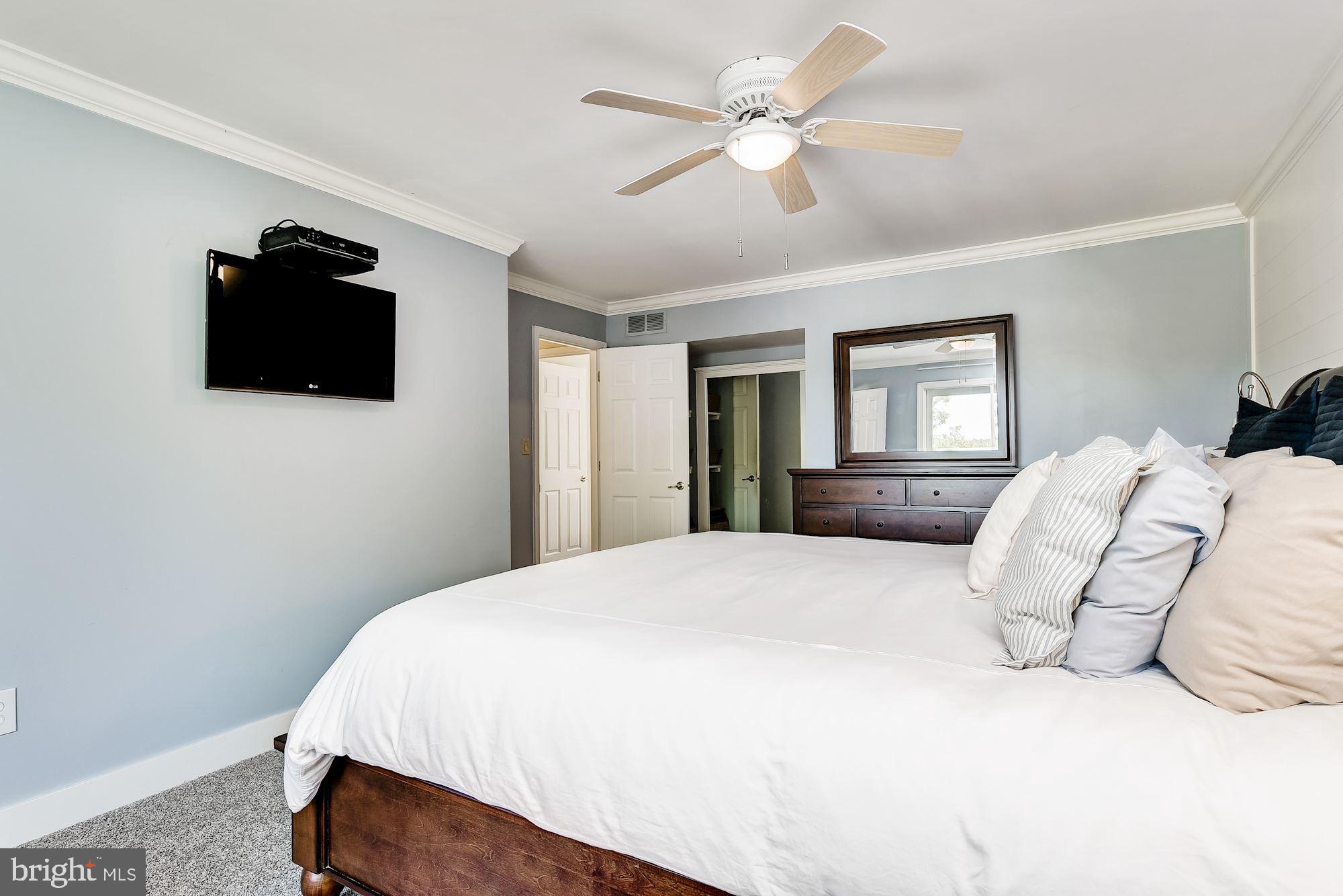 3069 Riverview Road Riva, MD 21140 - Photo 20 of 38 a bedroom with a bed a window and a flat screen tv