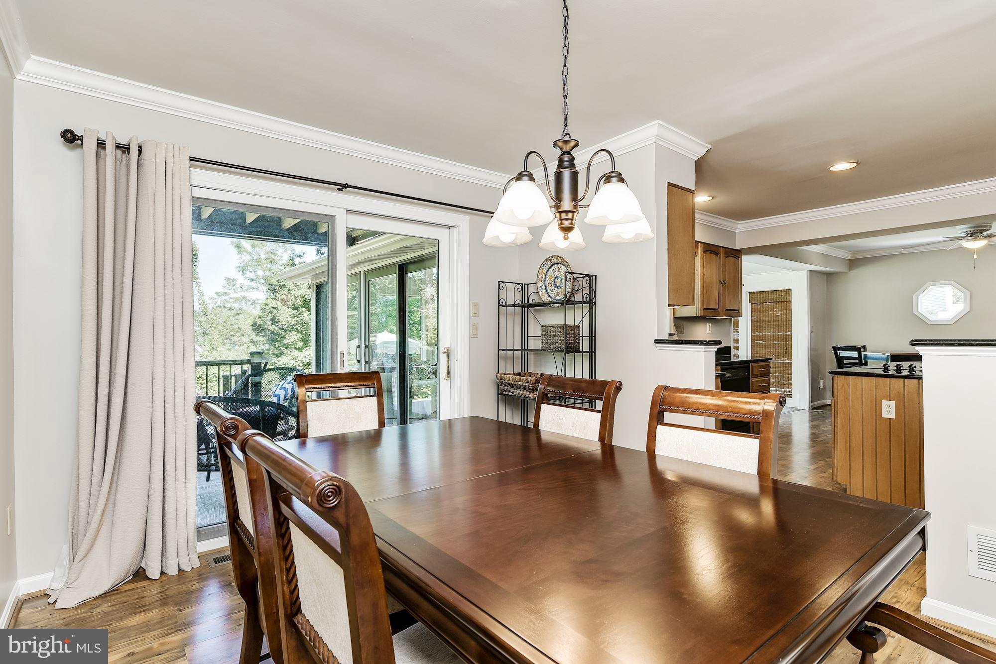 3069 Riverview Road Riva, MD 21140 - Photo 8 of 38 a view of a dining room and livingroom with furniture wooden floor a chandelier