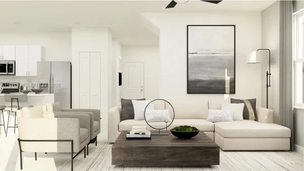 a living room with furniture and wooden floor