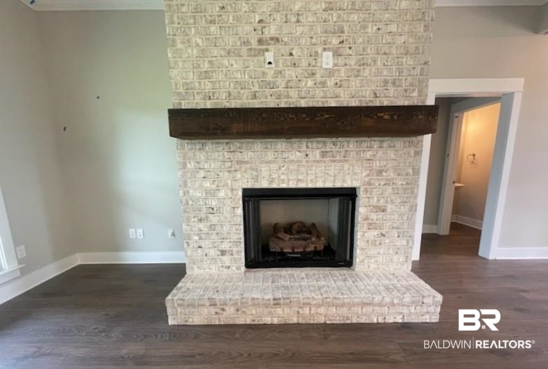 113 Daybreak Trail Fairhope, AL 36532 - Photo 3 of 45 Detailed view of crown molding, wood finished floors, and a brick fireplace