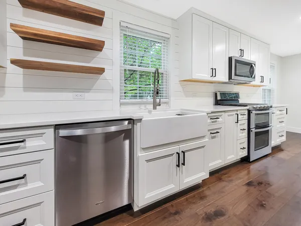 a kitchen with white cabinets and a stainless steel appliances