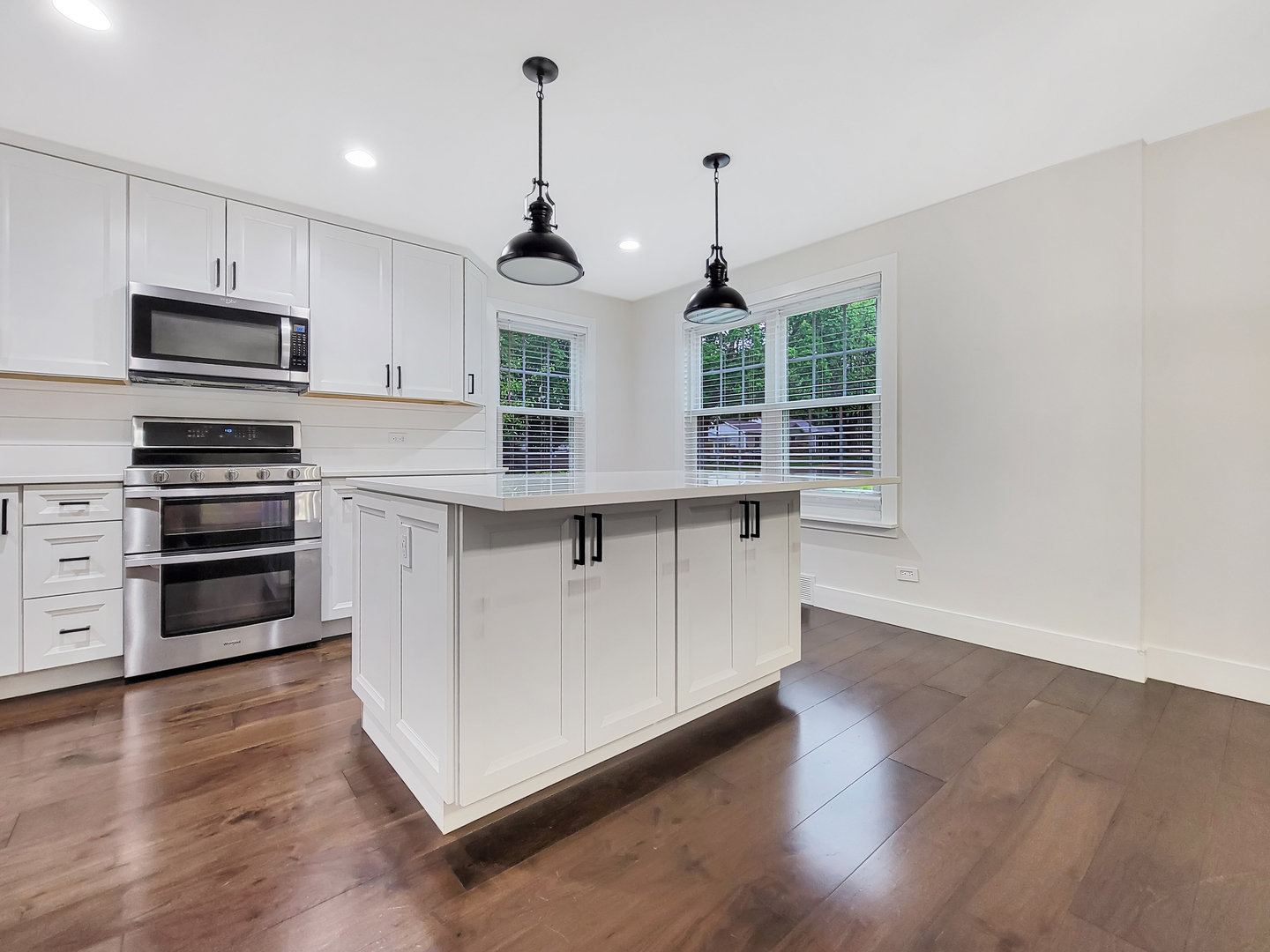401 South 4th Avenue Libertyville, IL 60048 - Photo 5 of 23 a kitchen with stainless steel appliances granite countertop a stove a sink and a wooden floor