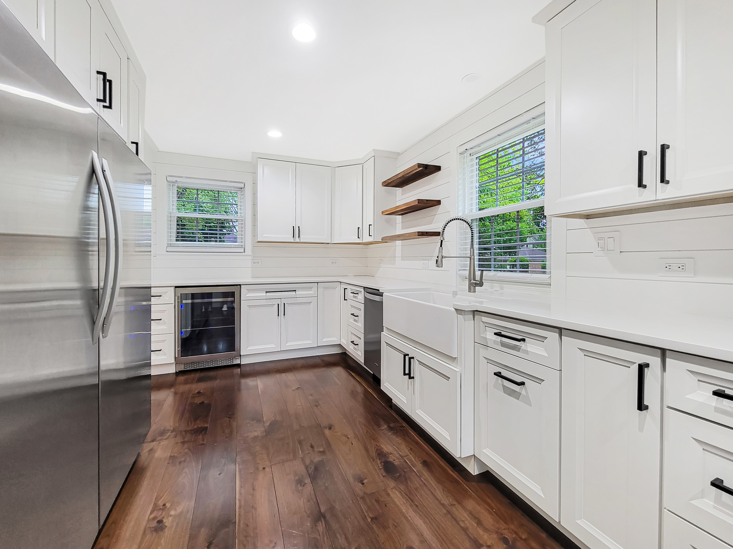 401 South 4th Avenue Libertyville, IL 60048 - Photo 7 of 23 a kitchen with granite countertop a stove a sink dishwasher a refrigerator and white cabinets with wooden floor