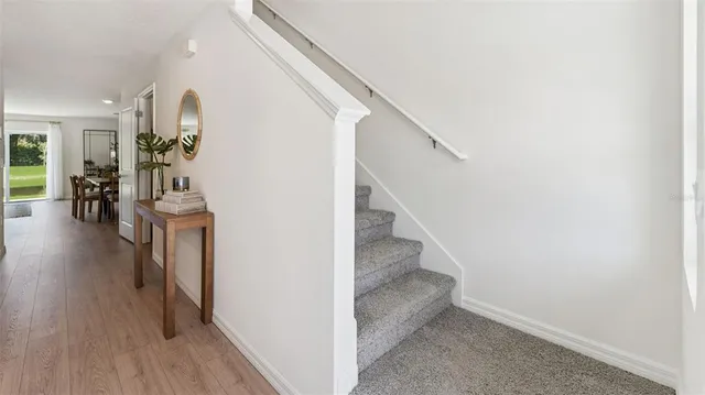 a view of entryway and hall with wooden floor