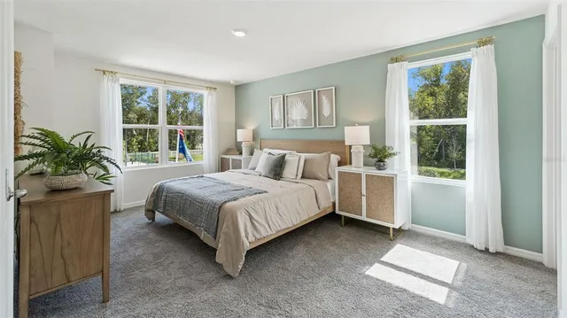 a bedroom with a large bed and a window