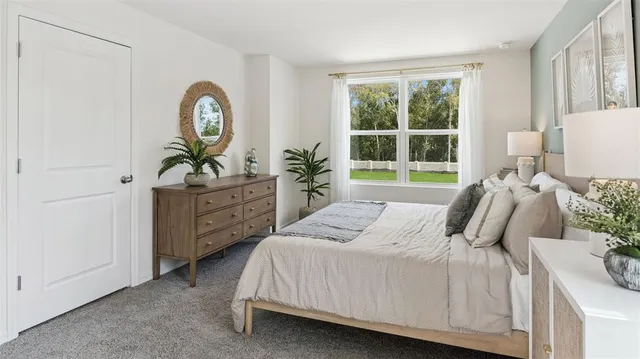 a bedroom with a bed a mirror and a window