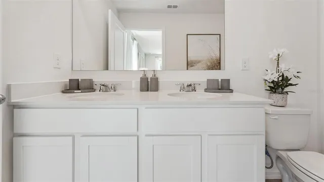a bathroom with a sink toilet and a mirror
