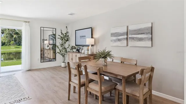 a view of a dining room with furniture and a potted plant