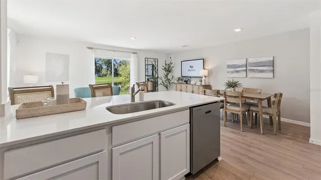 a kitchen with sink and view of living room