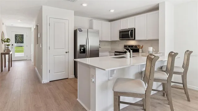 a kitchen with stainless steel appliances a refrigerator stove microwave and cabinets