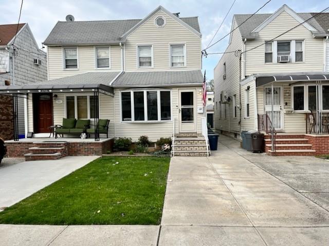 1717 East 37th Street Brooklyn, NY 11234 - Photo 1 of 12 a front view of a house with a yard