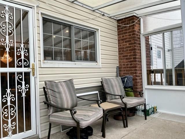 1717 East 37th Street Brooklyn, NY 11234 - Photo 12 of 12 a view of a patio with table and chairs and floor to ceiling window