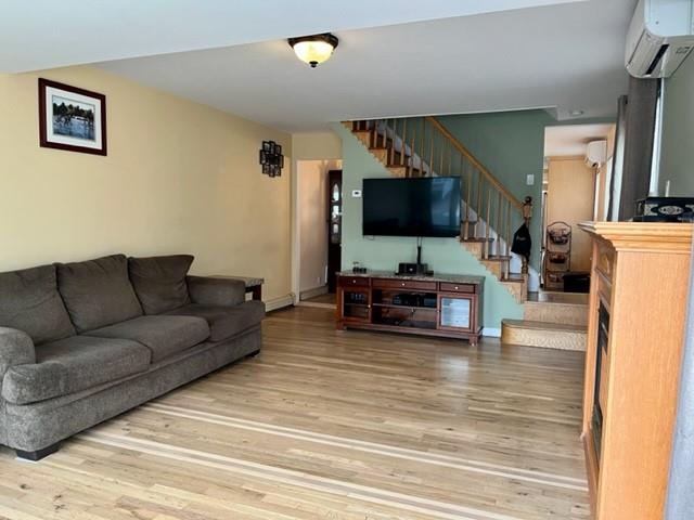 1717 East 37th Street Brooklyn, NY 11234 - Photo 2 of 12 a living room with furniture and a flat screen tv