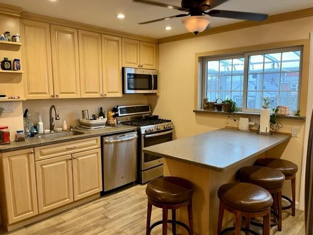 1717 East 37th Street Brooklyn, NY 11234 - Photo 6 of 12 a kitchen with stainless steel appliances a stove a sink cabinets and a dining table