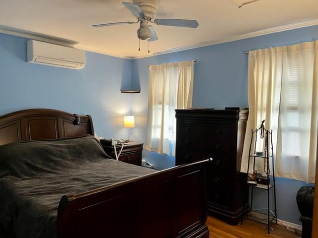 1717 East 37th Street Brooklyn, NY 11234 - Photo 7 of 12 a bedroom with a bed and wooden floor