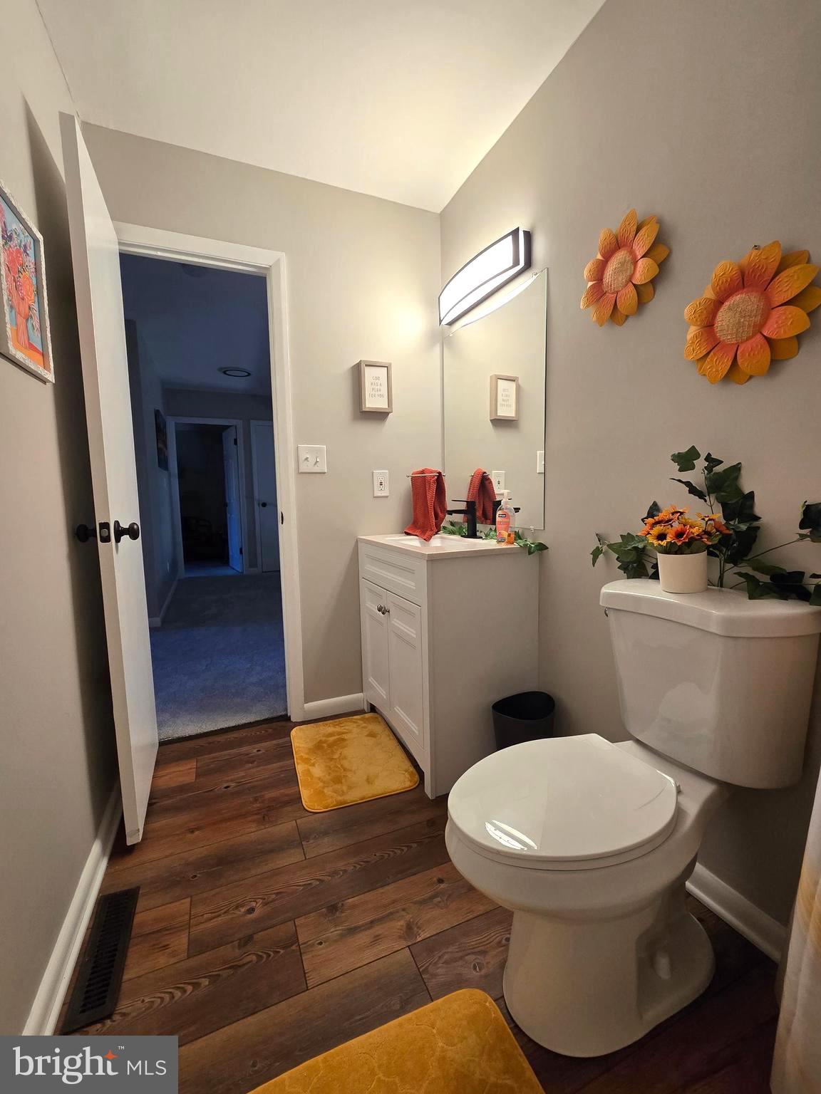 3435 Albantowne Way Edgewood, MD 21040 - Photo 19 of 24 a bathroom with a toilet a sink and mirror