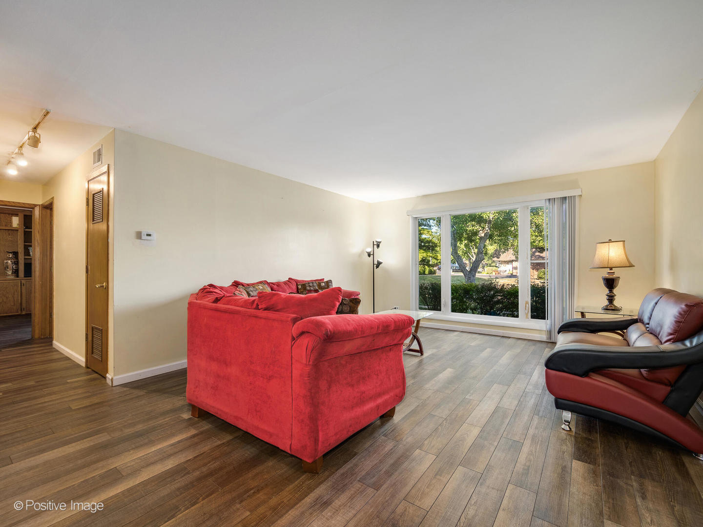 1322 South New Wilke Road, Unit 1C Arlington Heights, IL 60005 - Photo 7 of 20 a living room with furniture and a wooden floor