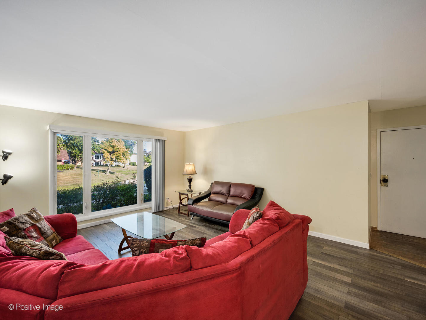 1322 South New Wilke Road, Unit 1C Arlington Heights, IL 60005 - Photo 8 of 20 a living room with furniture and a large window