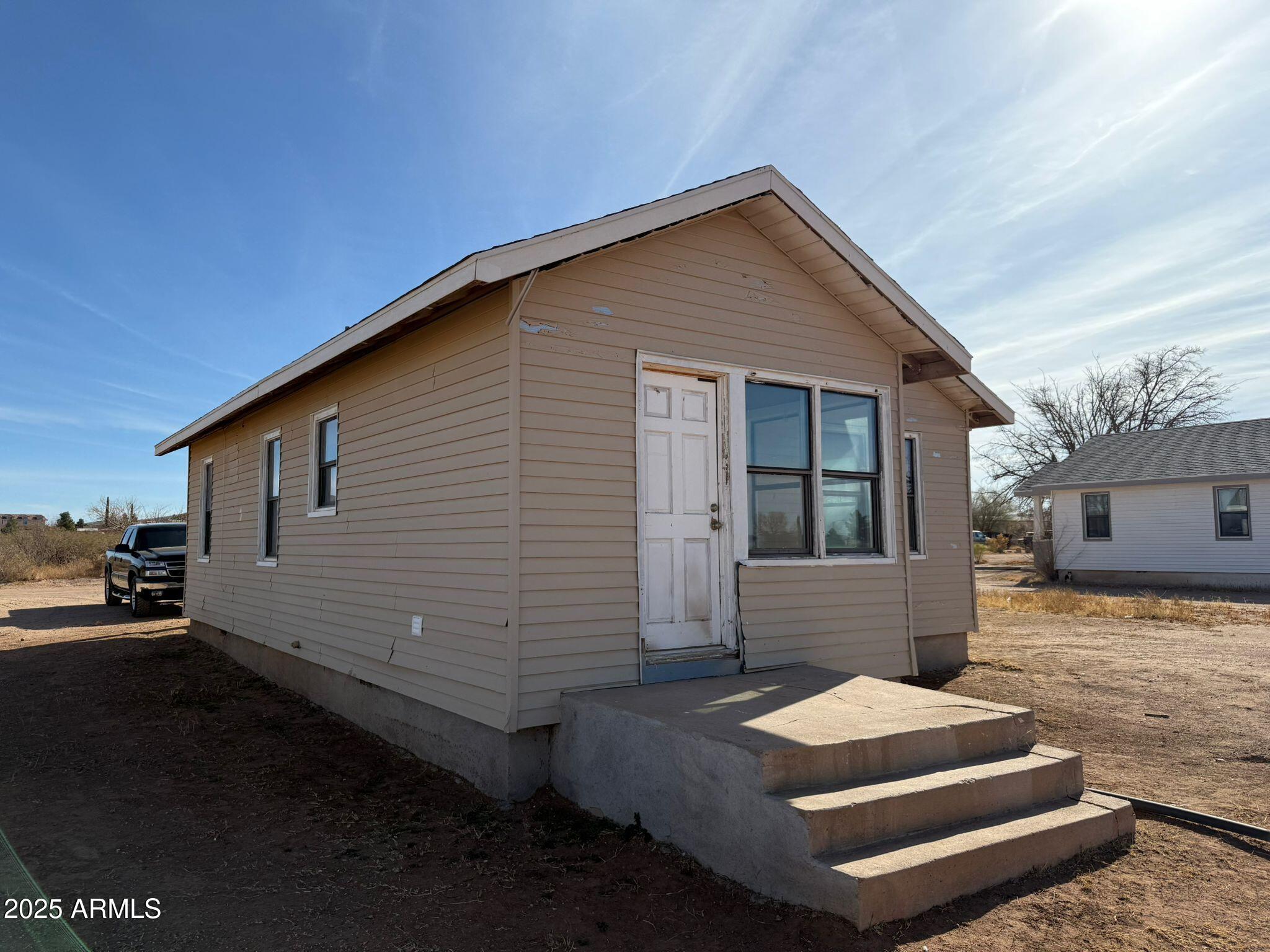 2082 North Cougar Place Douglas, AZ 85607 - Photo 16 of 16 a view of house with backyard and sitting area