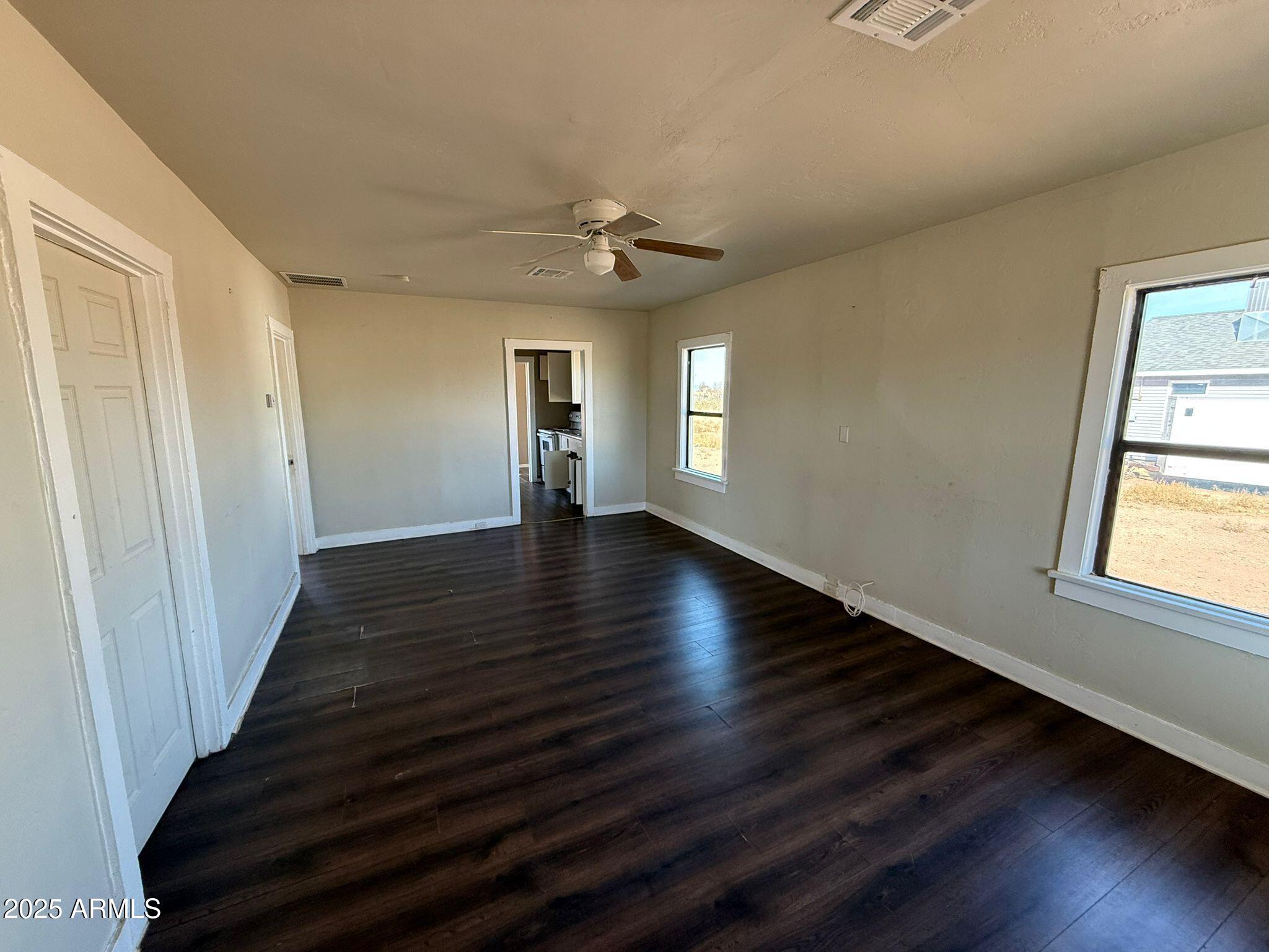 2082 North Cougar Place Douglas, AZ 85607 - Photo 2 of 16 wooden floor in an empty room with a window