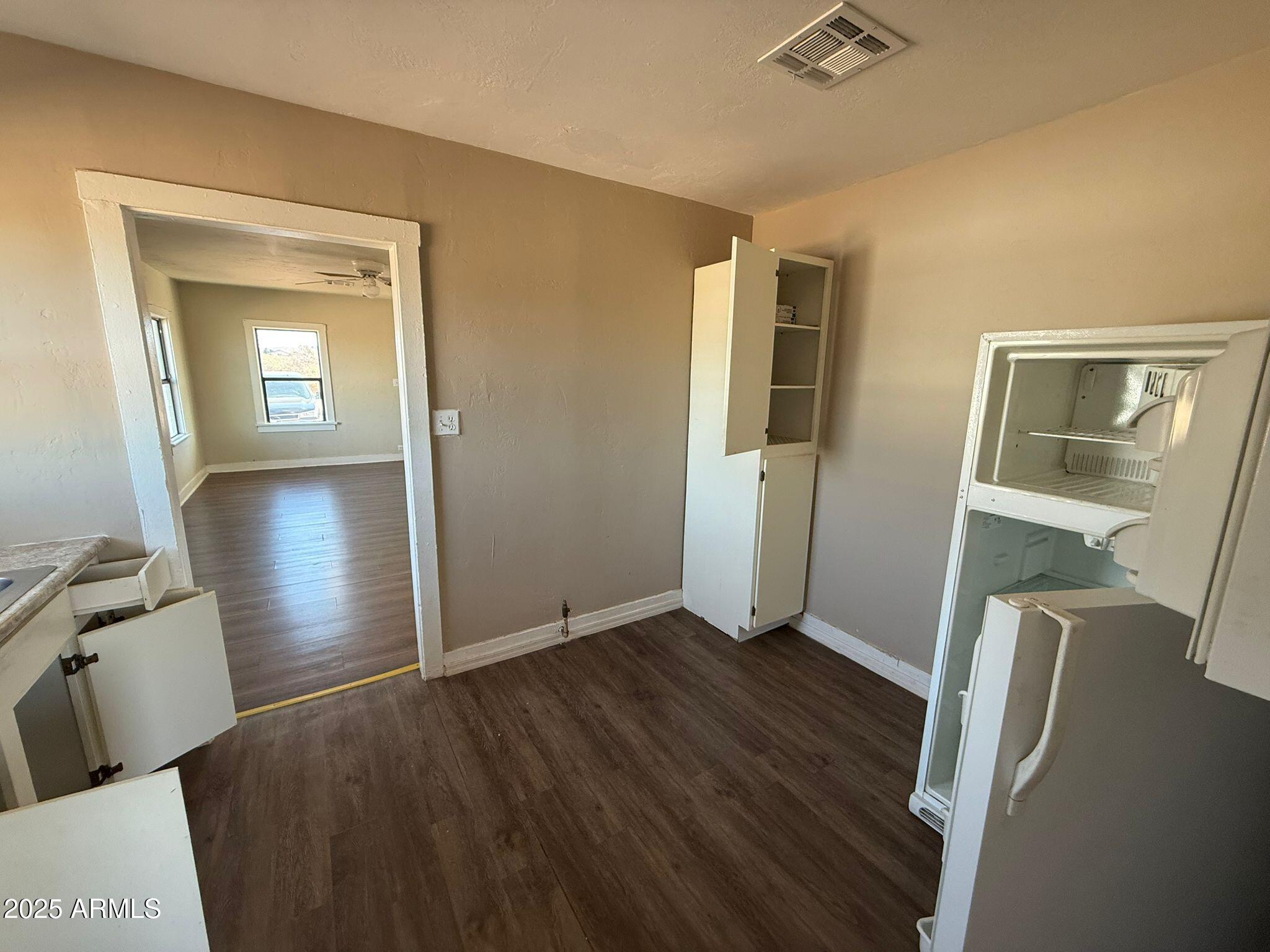 2082 North Cougar Place Douglas, AZ 85607 - Photo 5 of 16 wooden floor in an empty room with a mirror
