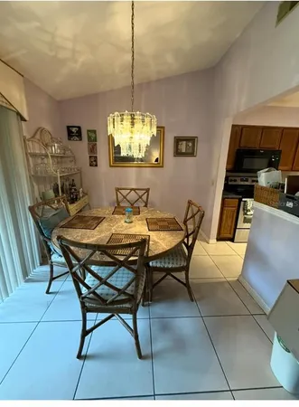 a dining room with furniture and chandelier