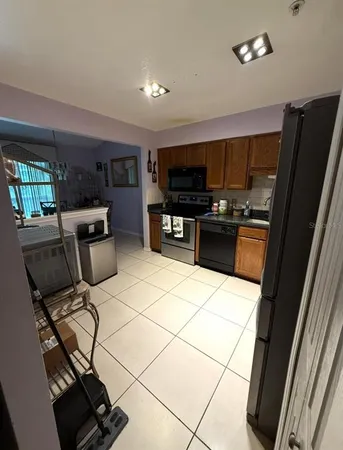 a kitchen with stainless steel appliances a stove a sink a microwave and a refrigerator