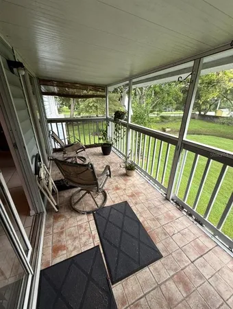 a bed sitting in a bedroom next to a large window
