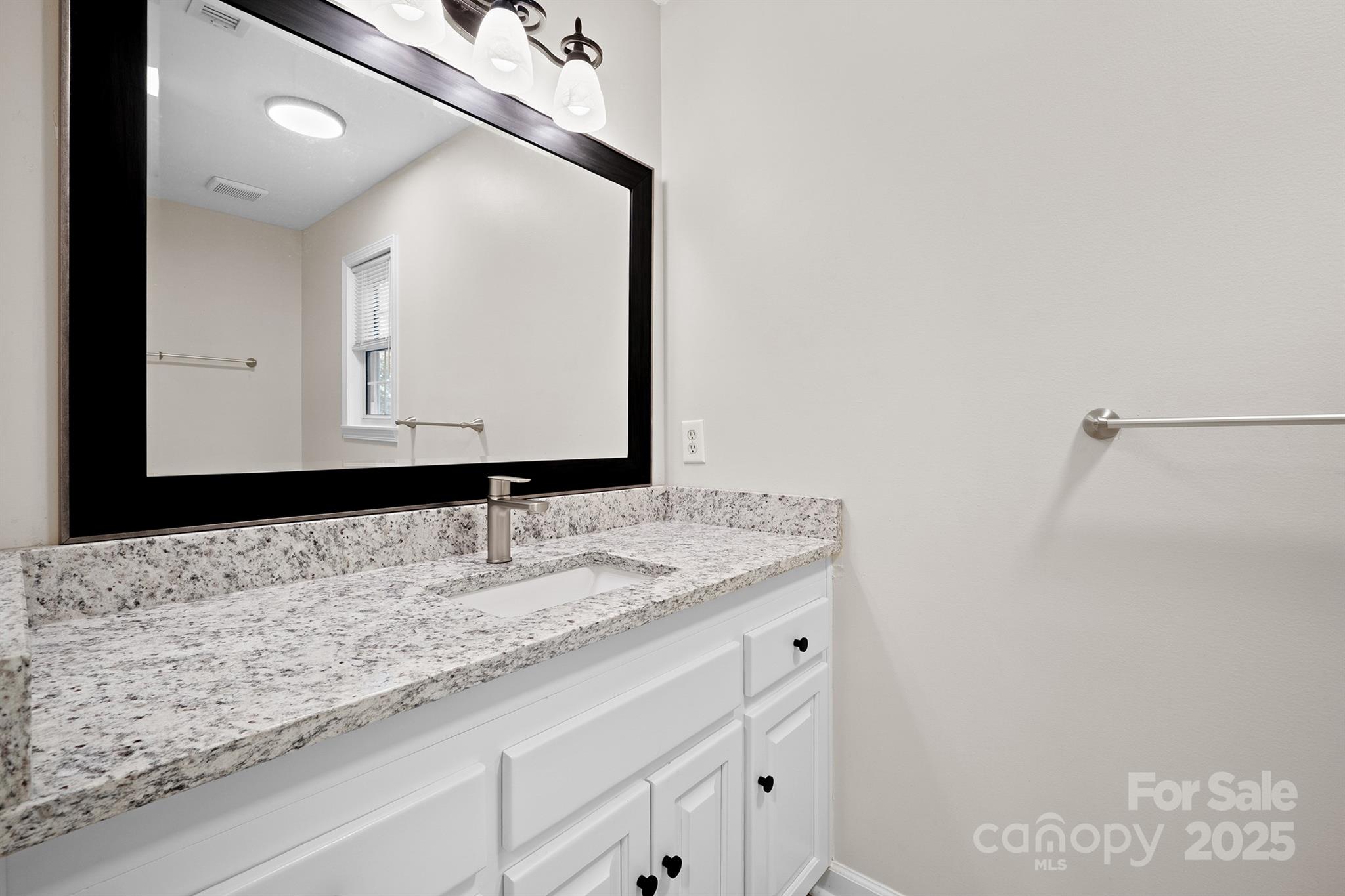 3024 Cross Tie Lane Matthews, NC 28105 - Photo 14 of 30 a bathroom with a granite countertop sink and a mirror
