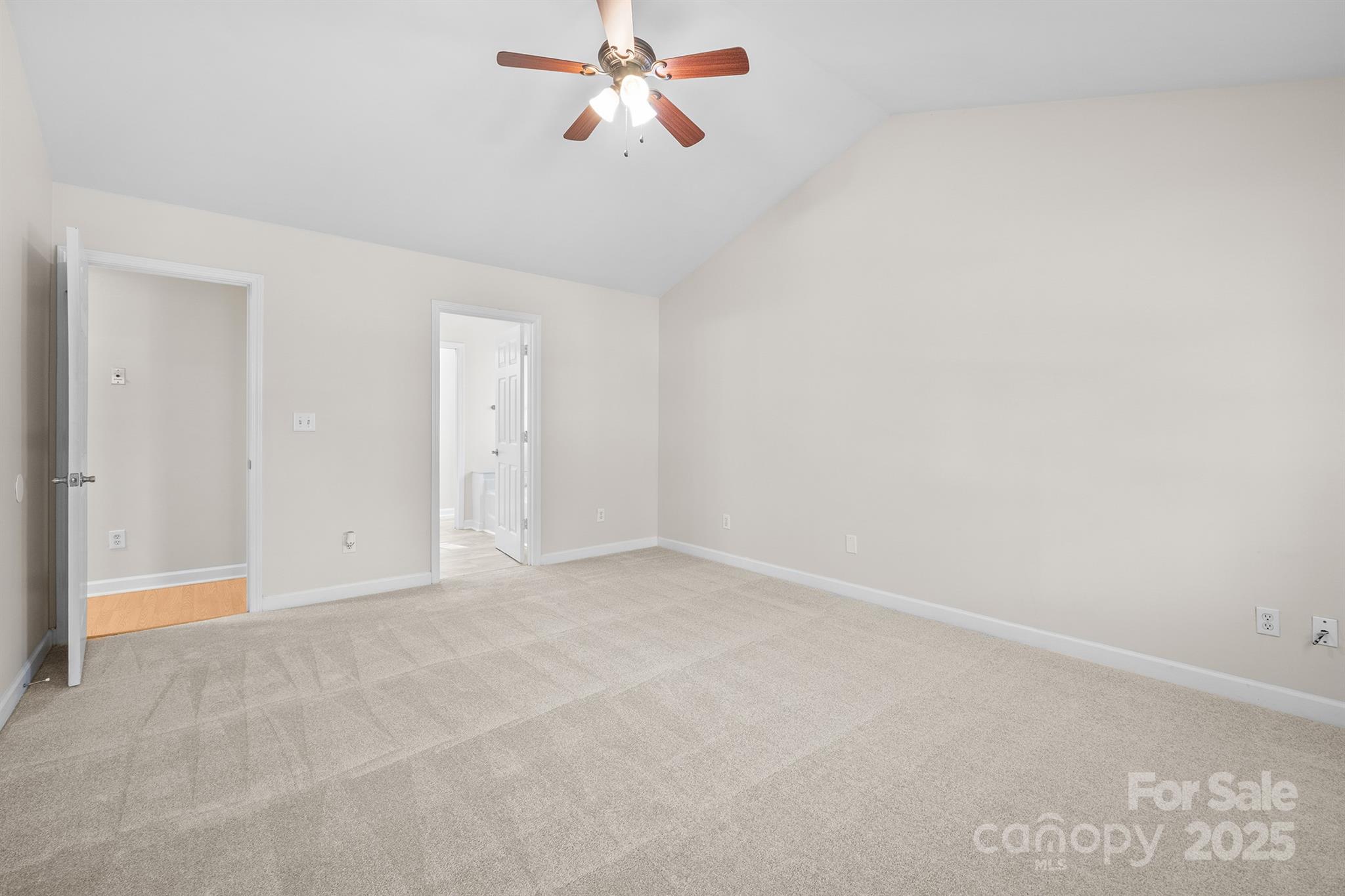 3024 Cross Tie Lane Matthews, NC 28105 - Photo 18 of 30 an empty room with chandelier fan and windows